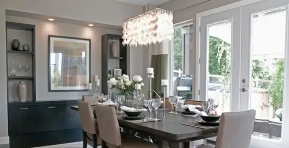 Elegant dining room chandelier installation above table in Saint Petersburg, FL