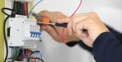 Electrician installing and adjusting circuit breakers in an electrical panel in Saint Petersburg, FL