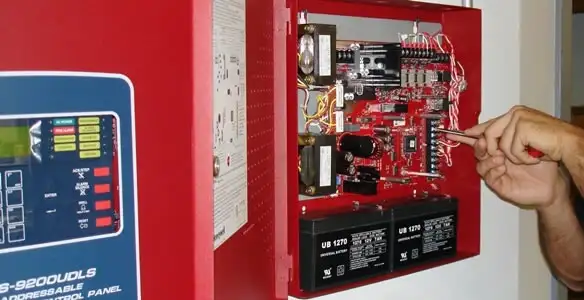 fire alarm installation service showing technician configuring fire alarm control panel in Saint Petersburg, FL